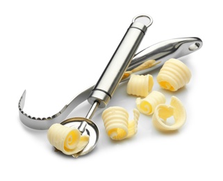 Photo of Utensils with butter curls on white background