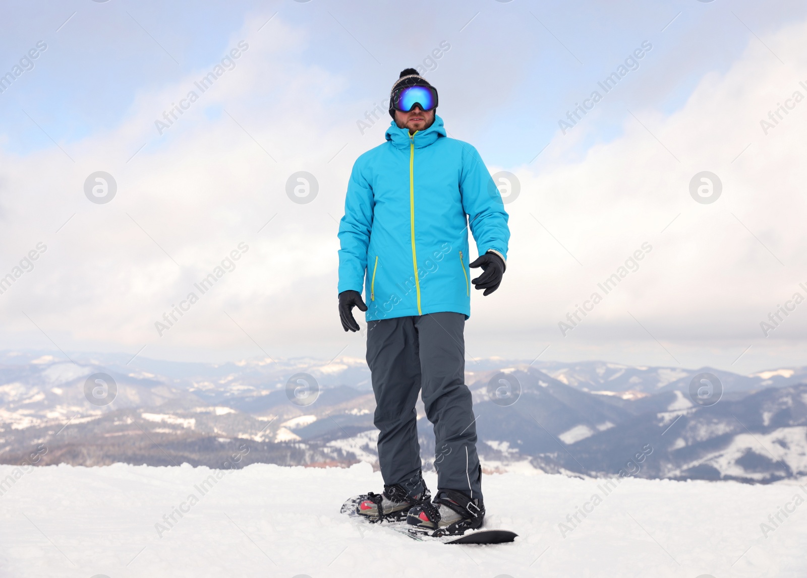 Photo of Male snowboarder on snowy hill. Winter vacation