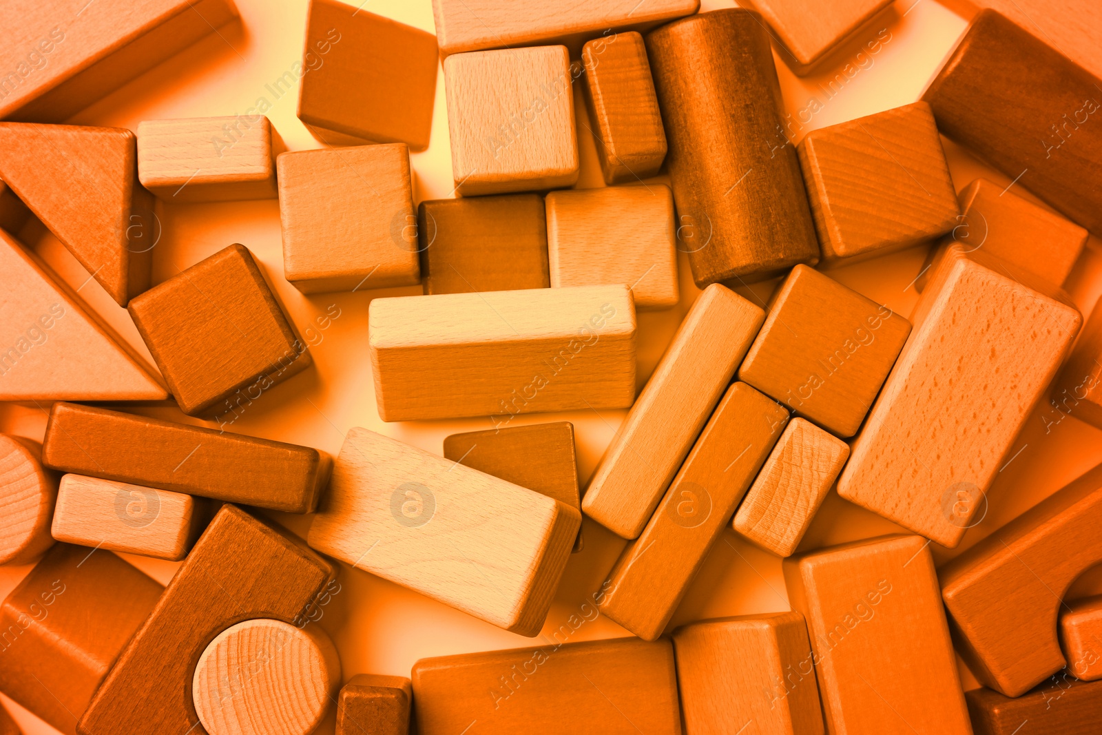 Image of Wooden construction set on background, top view. Toned in orange