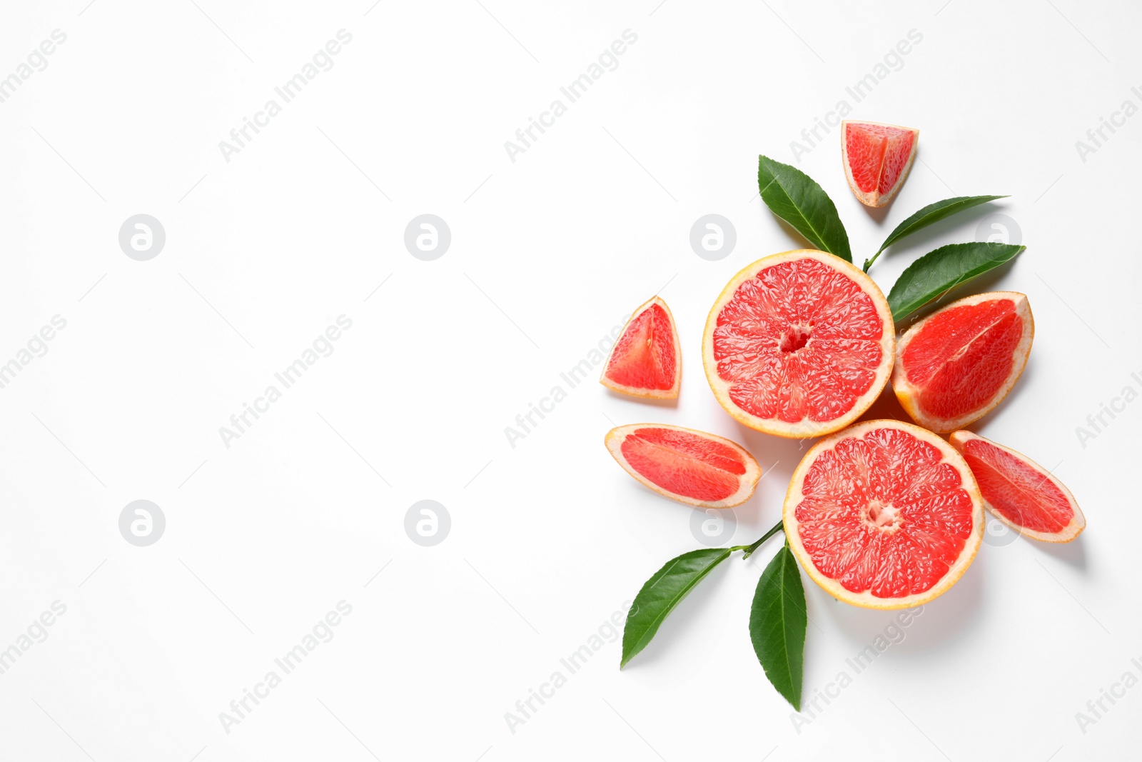 Photo of Grapefruits and leaves on white background, top view. Citrus fruits