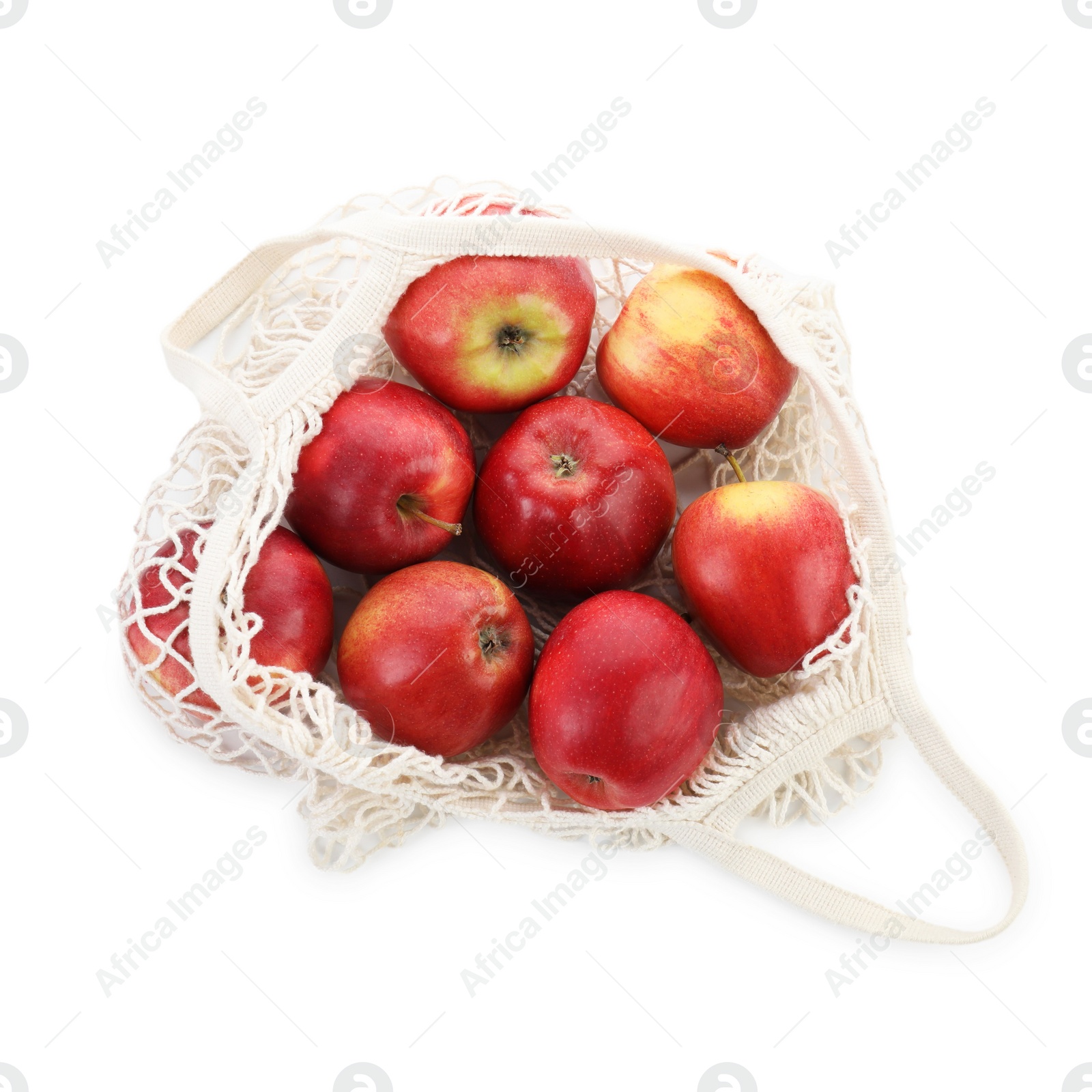 Photo of String bag with apples isolated on white, top view