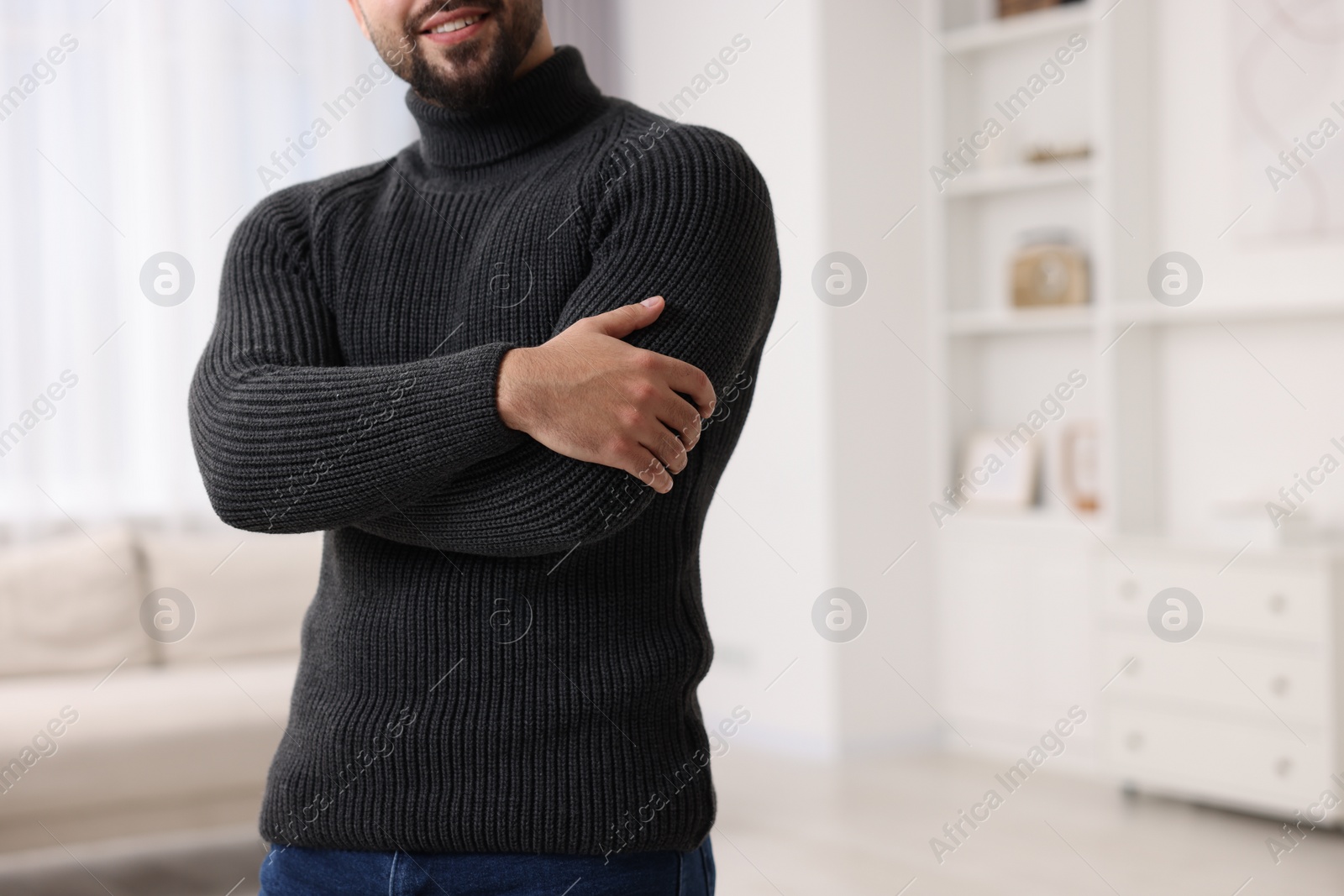 Photo of Man in stylish sweater at home, closeup. Space for text