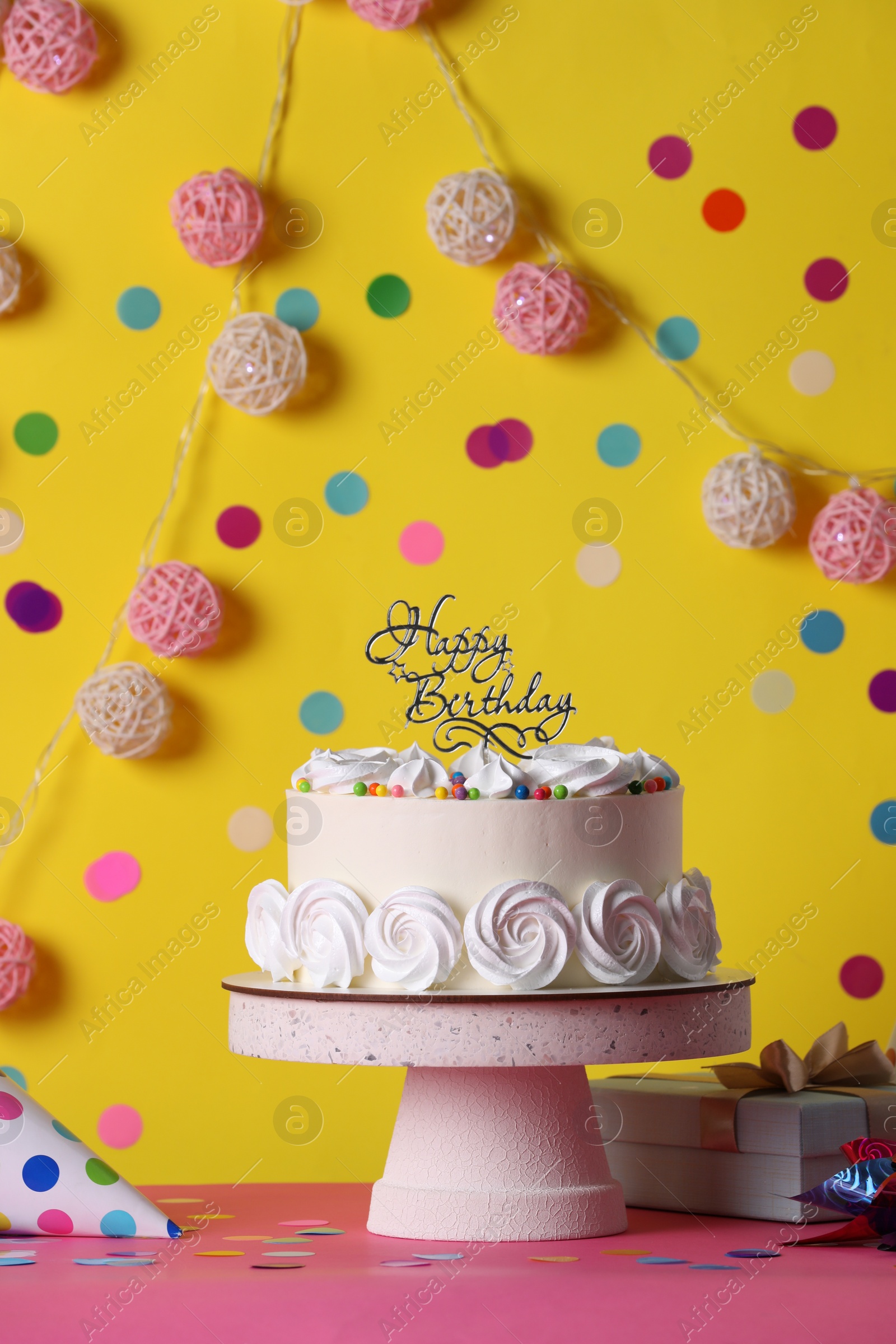 Photo of Beautiful birthday cake and decor on pink table