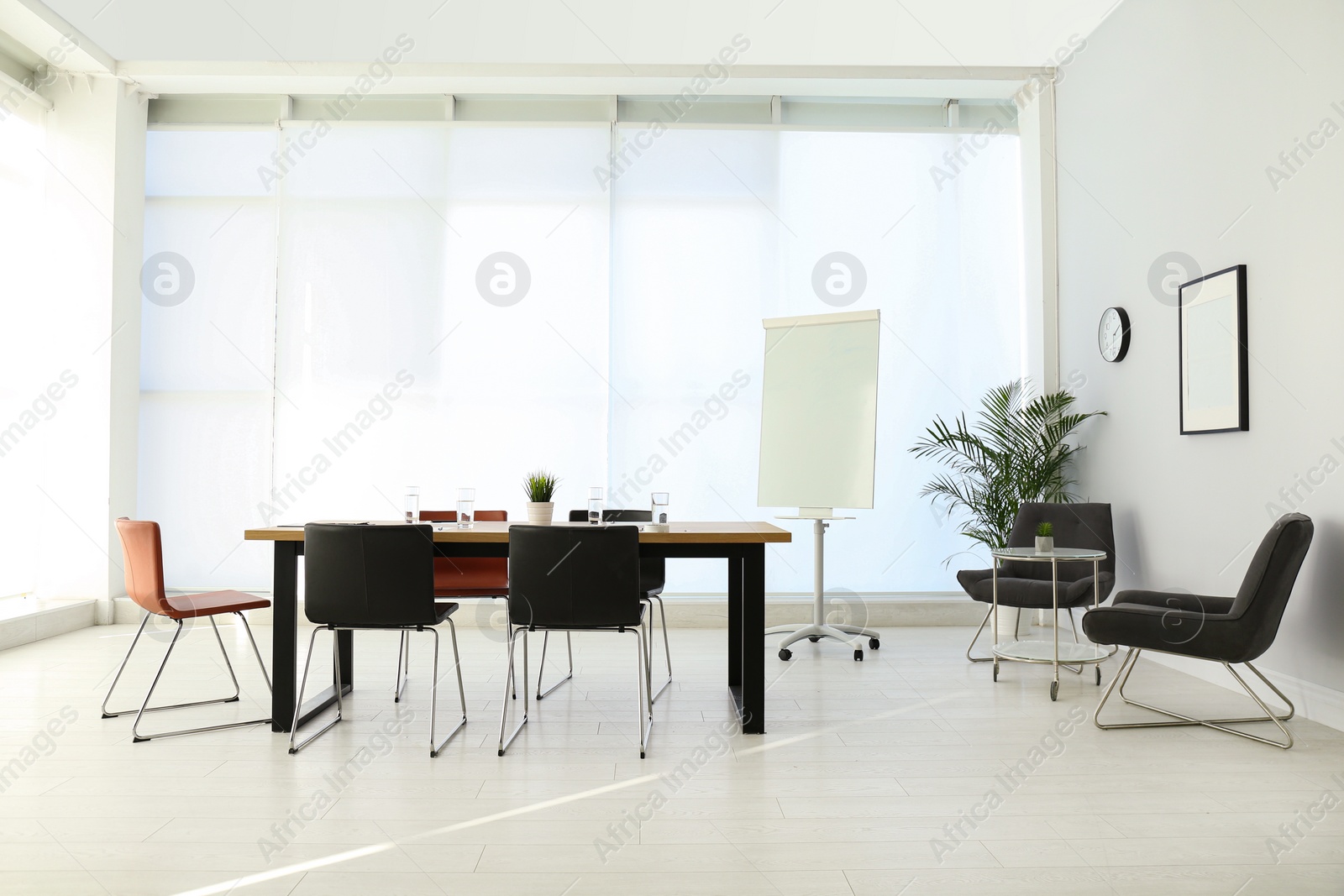 Photo of Simple office interior with large table and chairs