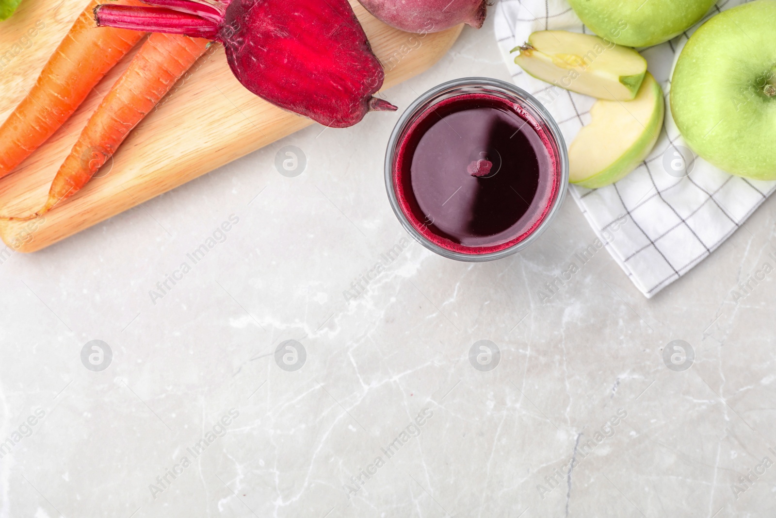 Photo of Glass of fresh juice and ingredients on table, top view