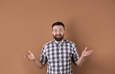 Portrait of handsome bearded man on color background