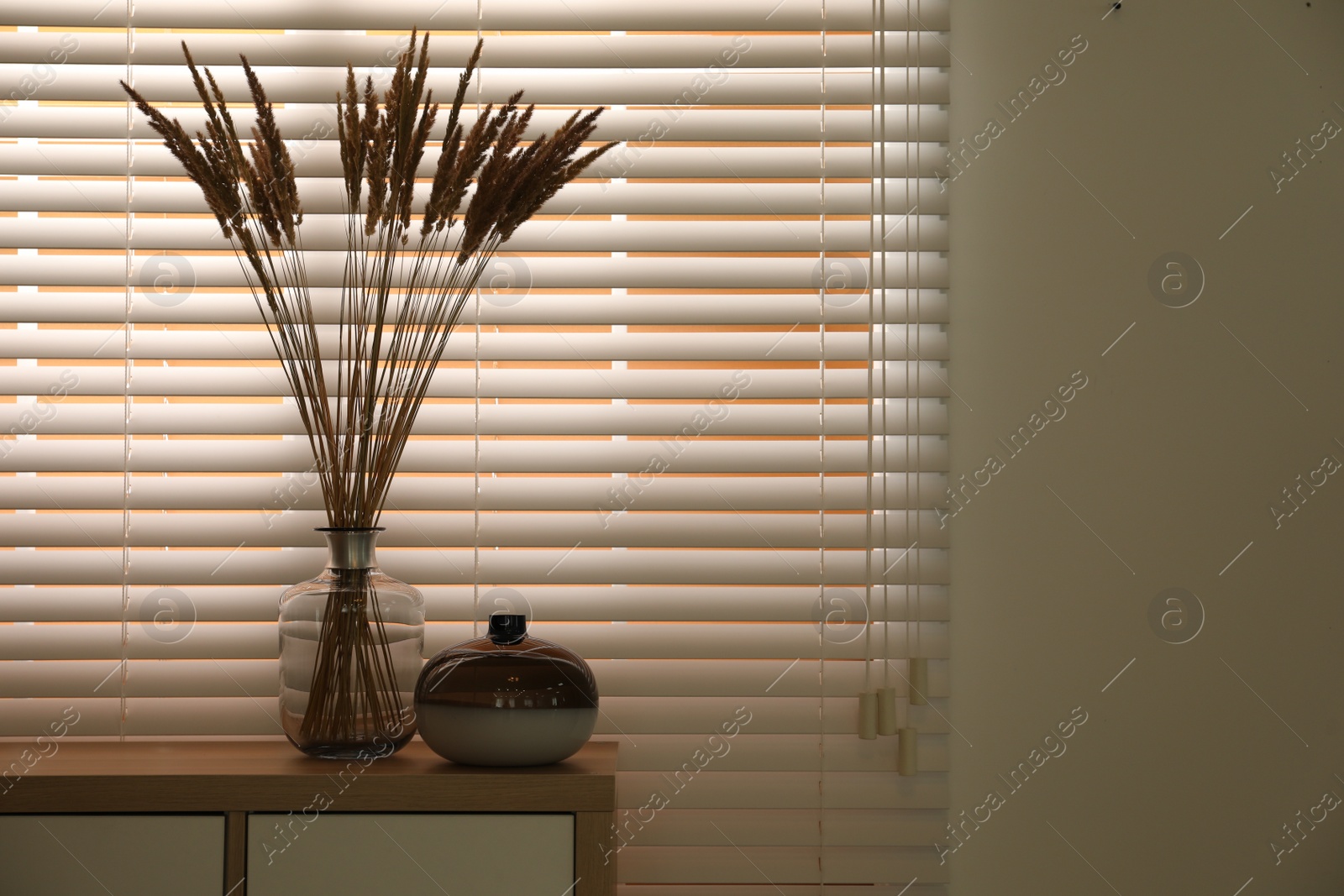 Photo of Decorative vases on commode near window indoors, space for text