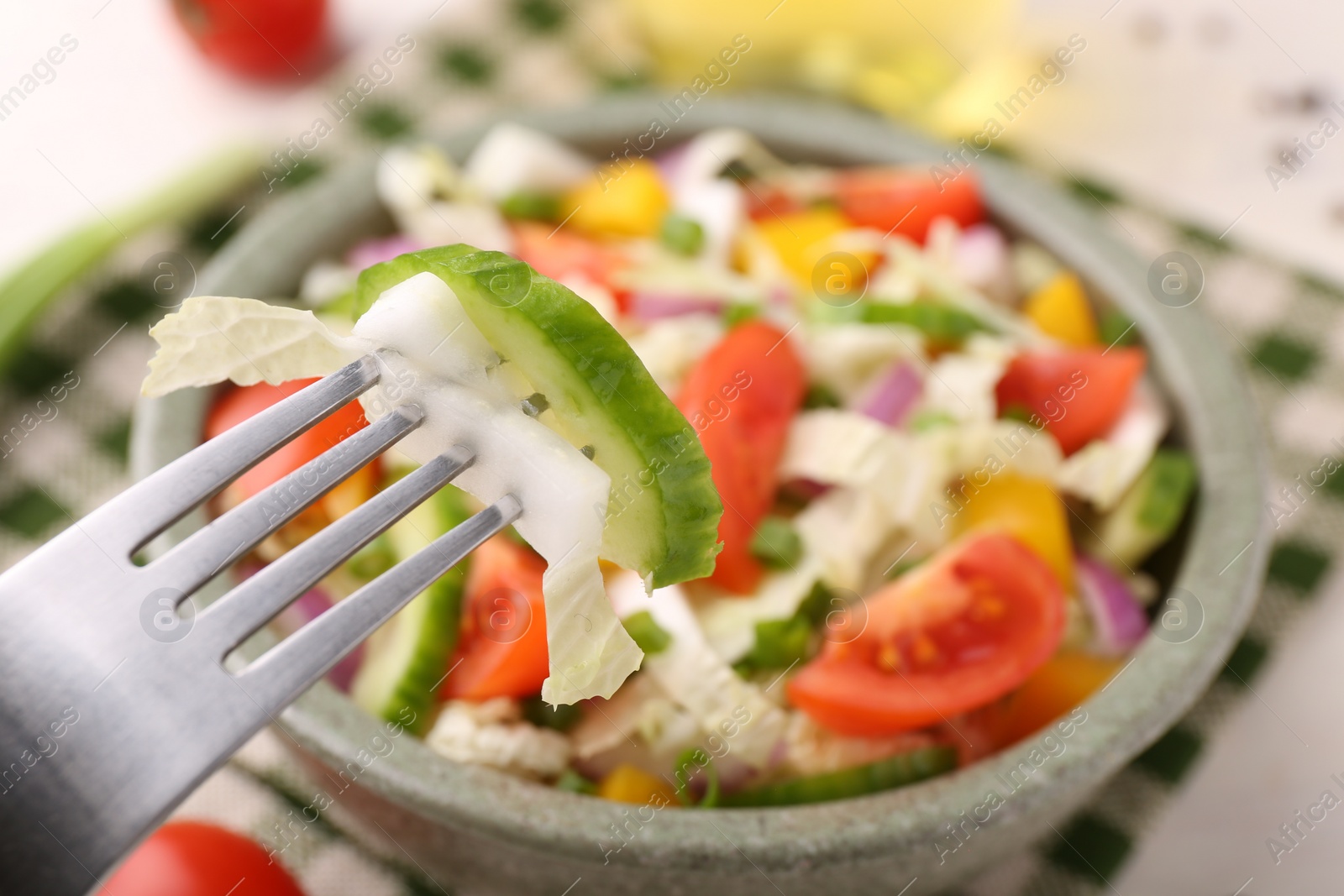 Photo of Eating delicious salad with Chinese cabbage at table, closeup