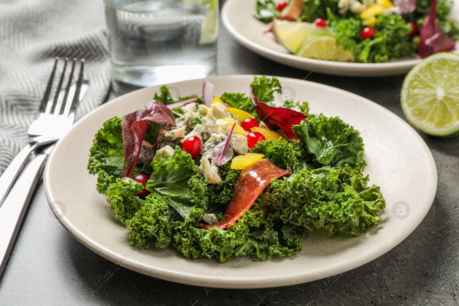 Photo of Tasty fresh kale salad on grey table