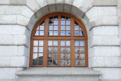 Photo of View of beautiful arched window in building outdoors