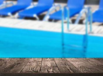 Image of Wooden deck near swimming pool outdoors on sunny day. Space for text