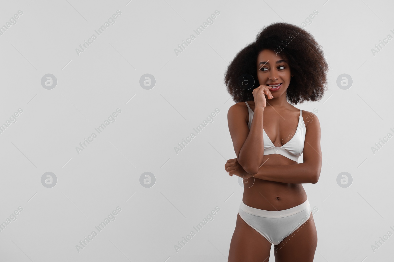 Photo of Beautiful woman in stylish bikini on white background, space for text