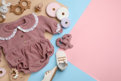 Flat lay composition with baby clothes and accessories on color background. Space for text