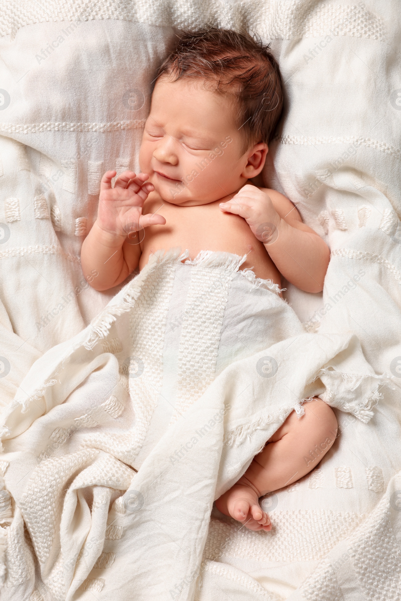 Photo of Cute newborn baby sleeping on white blanket, top view