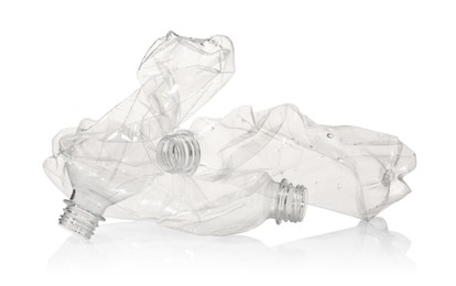 Photo of Crumpled disposable plastic bottles isolated on white