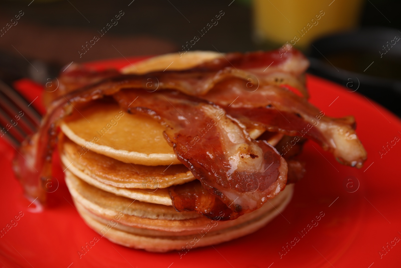 Photo of Delicious pancakes with bacon on table, closeup