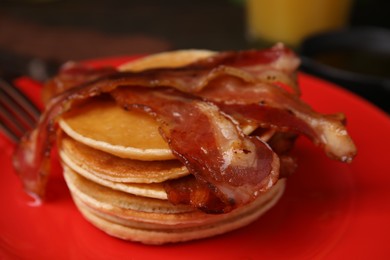 Delicious pancakes with bacon on table, closeup