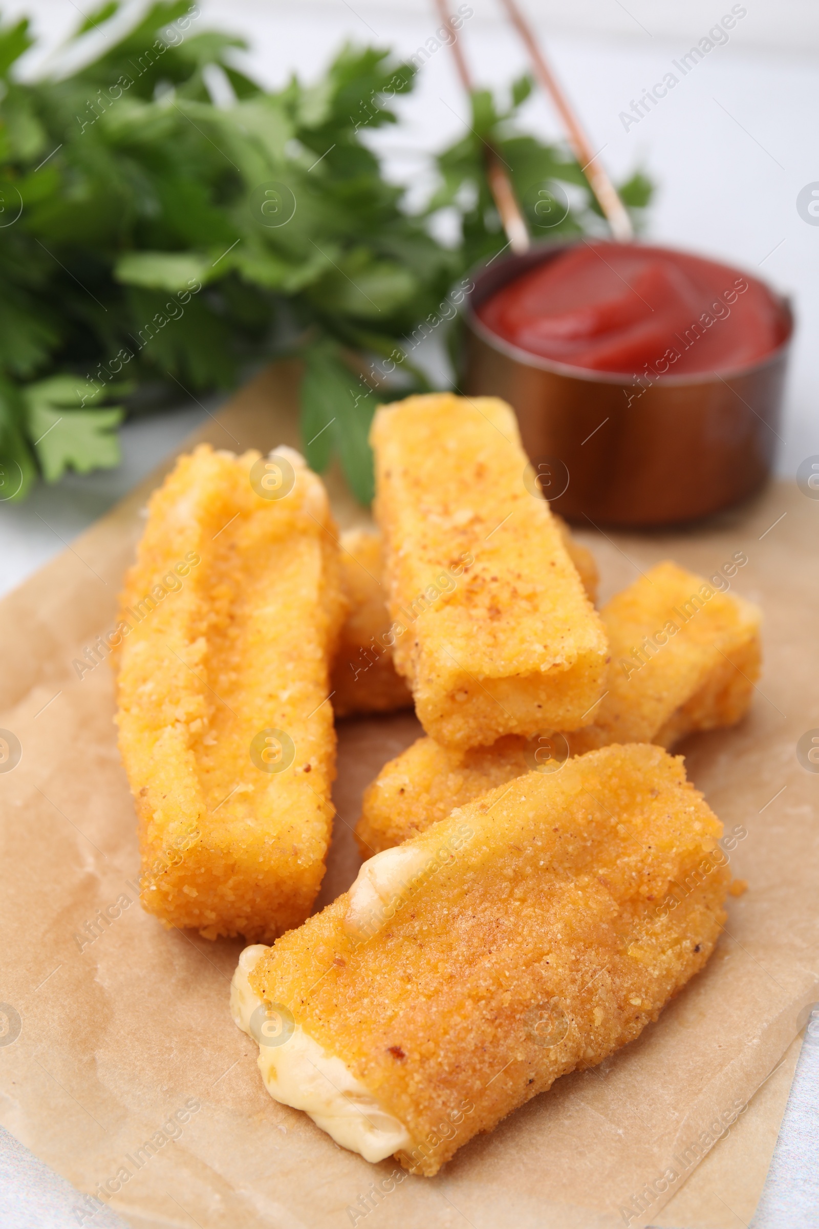 Photo of Tasty fried mozzarella sticks on table, closeup