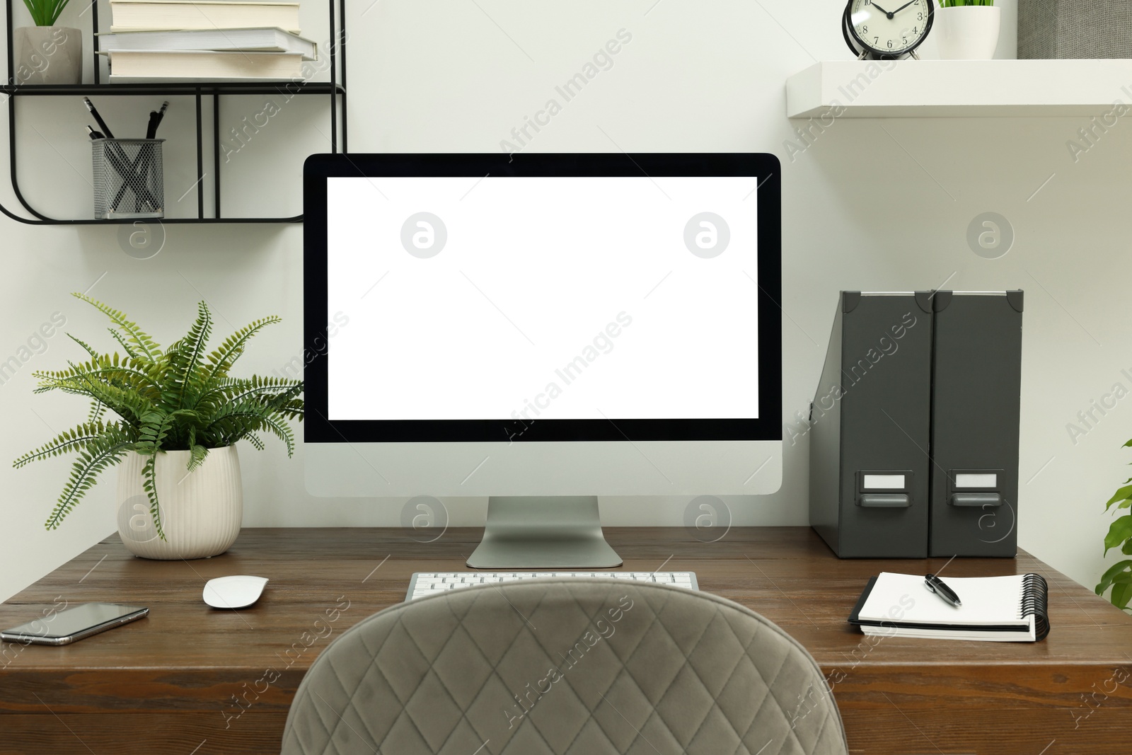 Image of Comfortable workplace at home. Modern computer with blank screen and stationery on wooden desk. Mockup for design