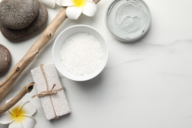 Flat lay composition with different spa products on white marble table. Space for text