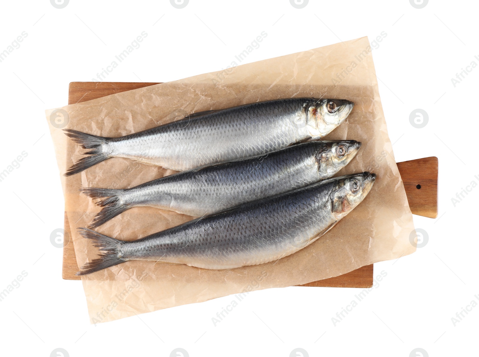 Photo of Wooden board with salted herrings isolated on white, top view