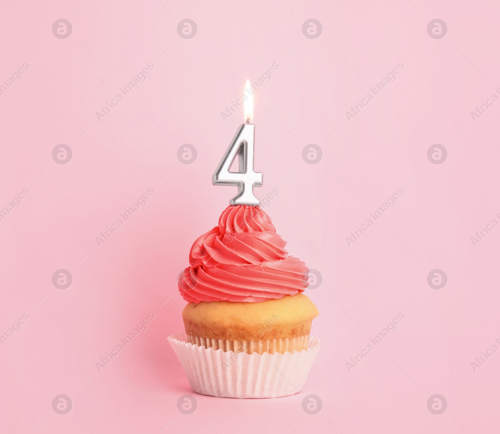 Photo of Birthday cupcake with number four candle on pink background