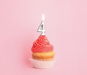 Birthday cupcake with number four candle on pink background