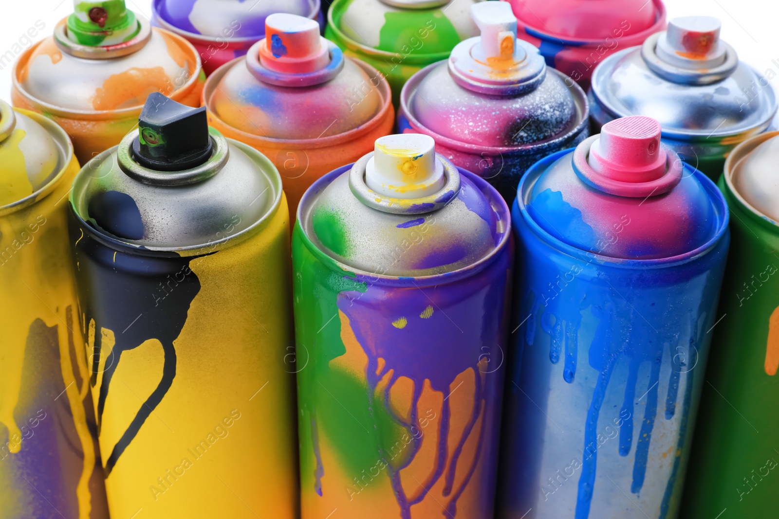 Photo of Used cans of spray paints on white background, closeup. Graffiti supplies