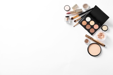 Different luxury makeup products on white background, top view
