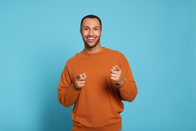 Photo of Portrait of happy African American man on light blue background