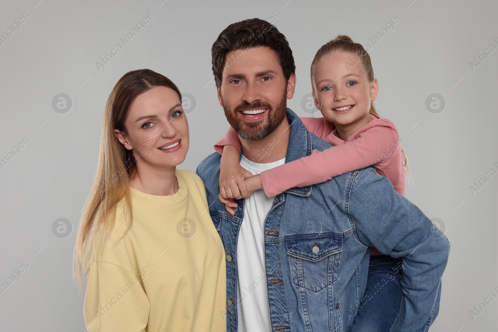 Photo of Portrait of happy family on light grey background