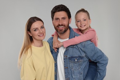 Photo of Portrait of happy family on light grey background