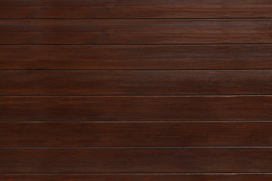 Photo of Texture of wooden board on black background, top view