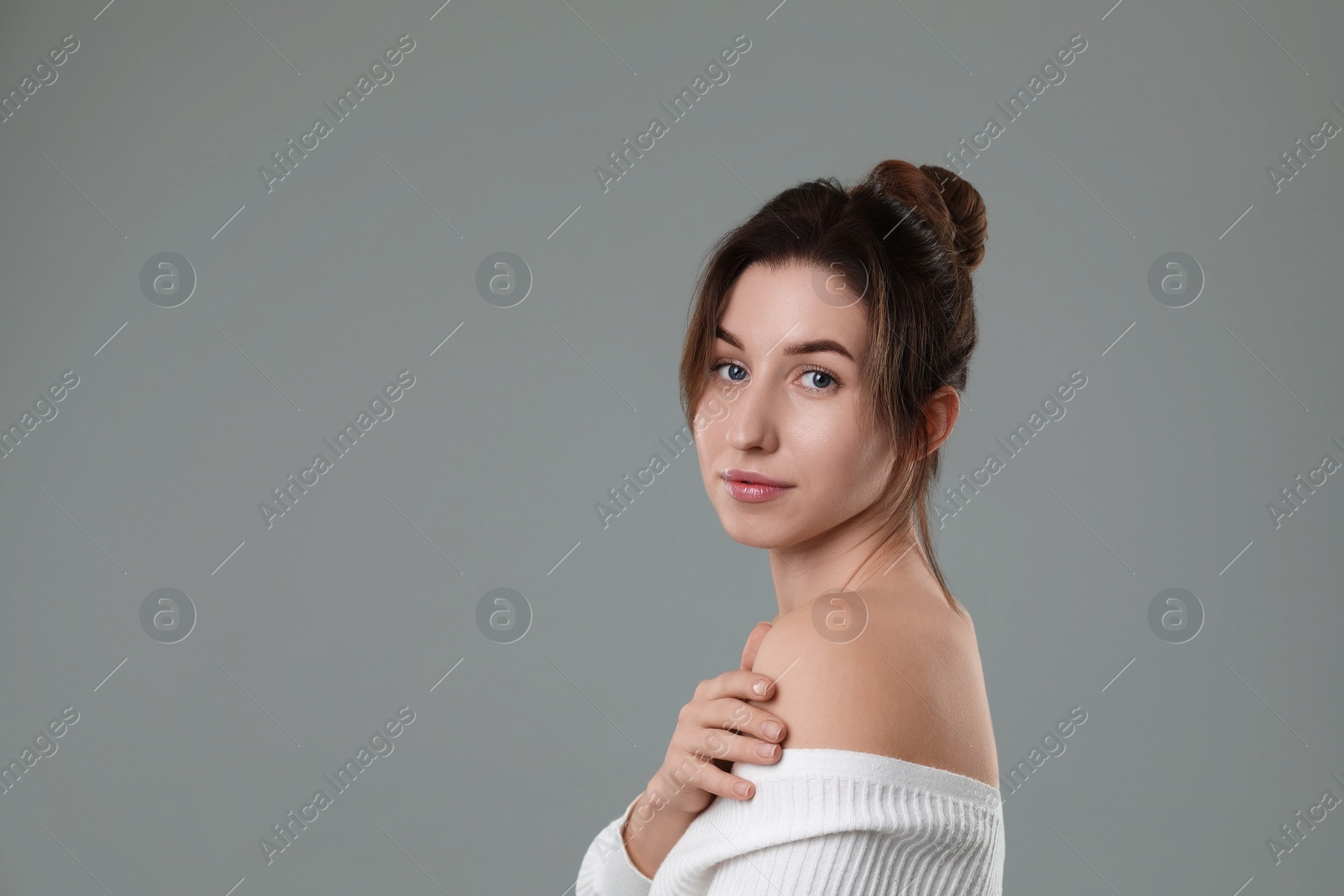 Photo of Portrait of beautiful young woman on grey background, space for text