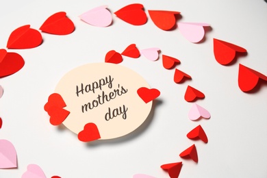 Photo of Greeting card with phrase "HAPPY MOTHER'S DAY" and paper hearts on white background