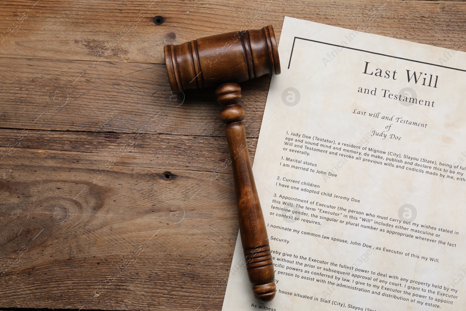 Photo of Last Will and Testament with gavel on wooden table, top view. Space for text