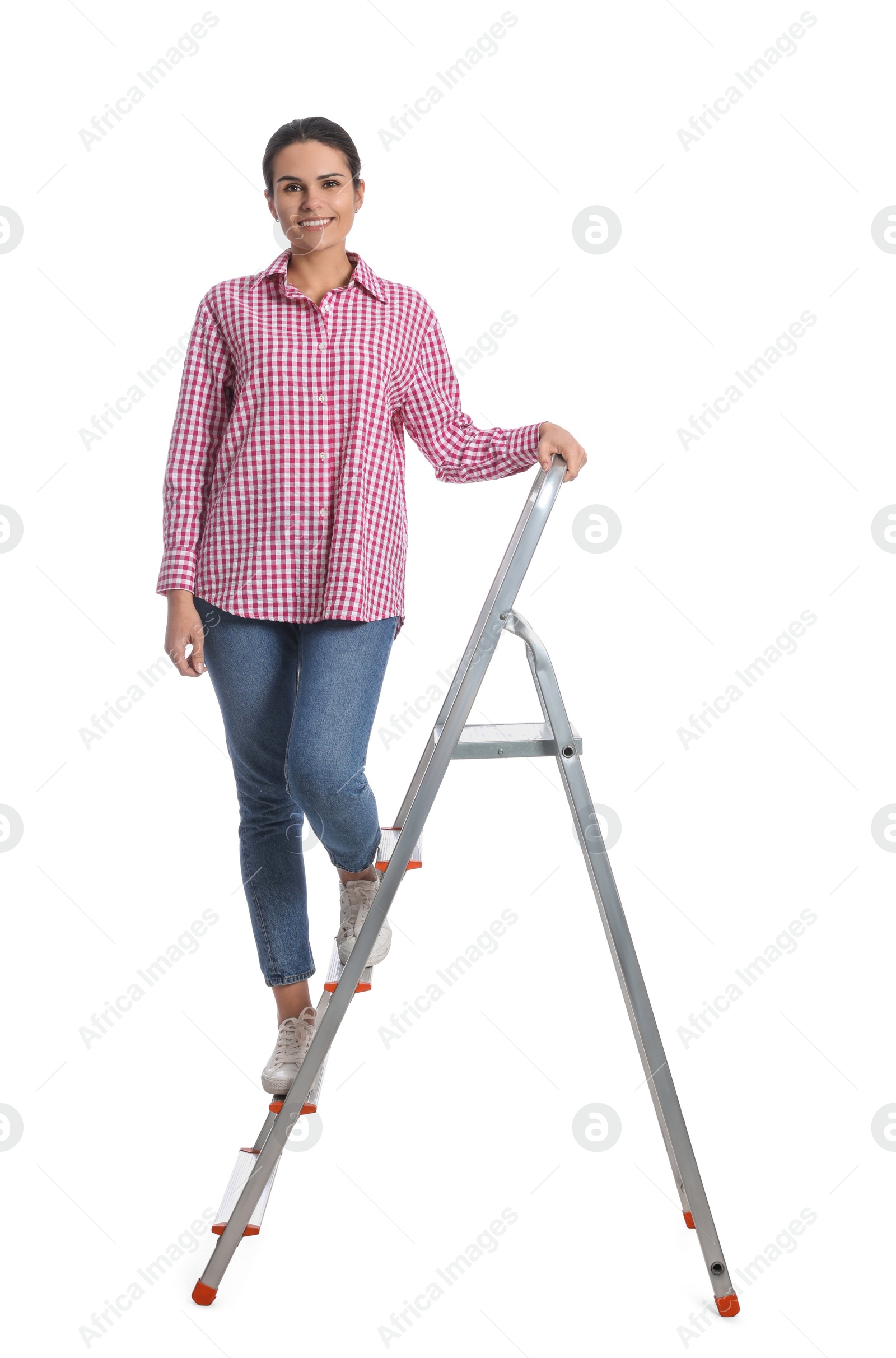 Photo of Young woman on metal ladder against white background