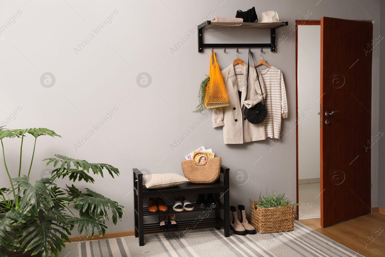 Photo of Hallway interior with stylish furniture, clothes and accessories