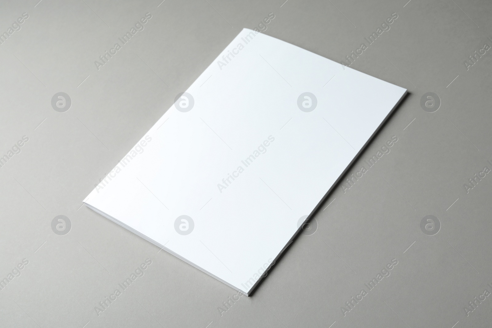 Photo of Brochure with blank cover on grey background. Mock up for design