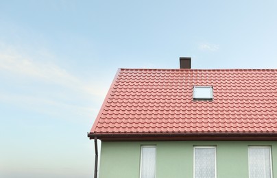 Photo of Beautiful house with red roof against blue sky