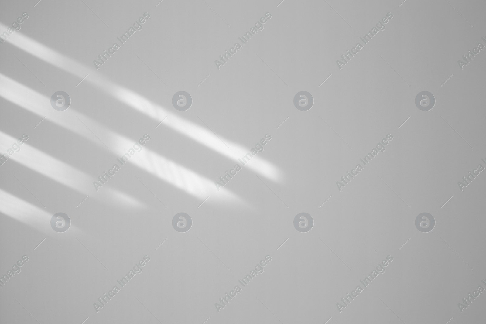 Image of Light and shadows falling on white wall