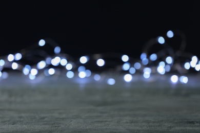 Beautiful lights on grey table, blurred view