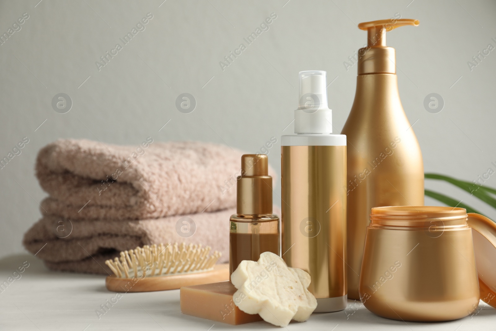 Photo of Composition with hair care cosmetic products on white table. Space for text