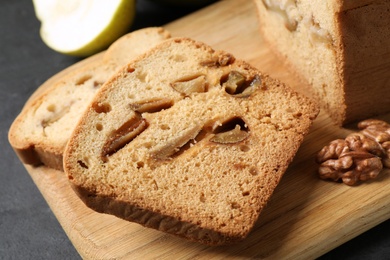 Tasty cut pear bread on black table, closeup. Homemade cake