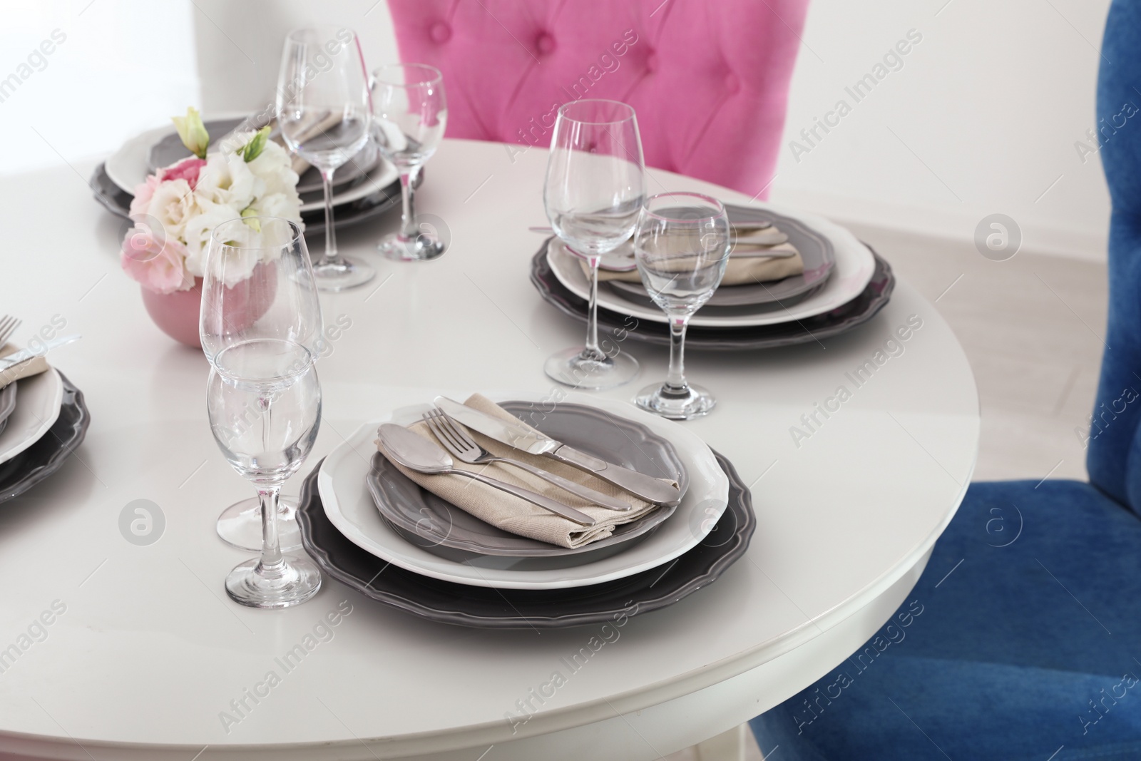 Photo of Beautiful table setting in modern dining room interior