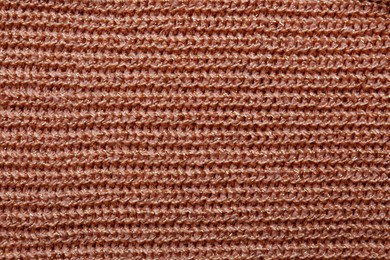 Photo of Brown knitted fabric as background, top view