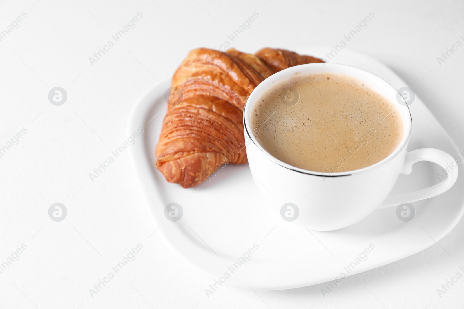 Photo of Breakfast time. Fresh croissant and coffee on white background. Space for text