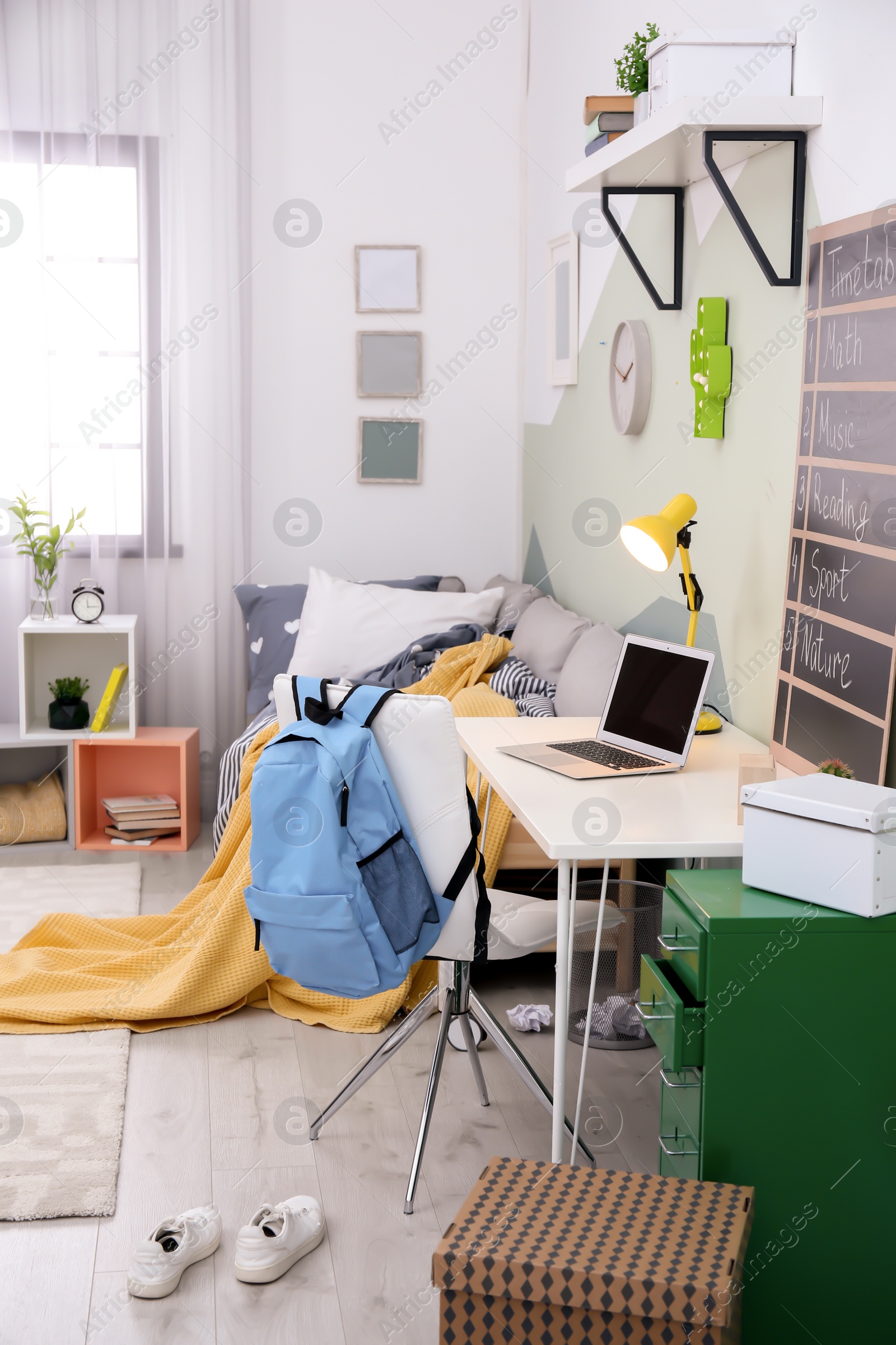 Photo of Modern child room interior with desk and laptop