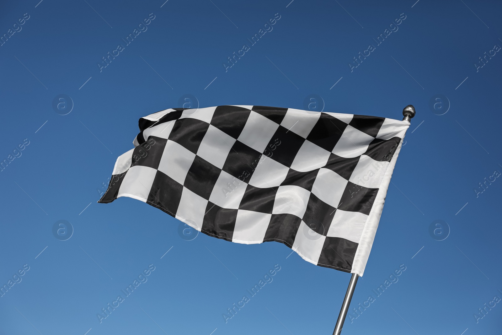 Photo of Checkered finish flag on light blue background