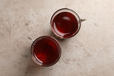 Glasses of traditional Turkish tea on light grey table, flat lay